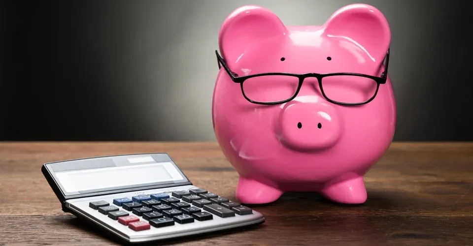 A piggy bank and calculator representing user acquisition costs