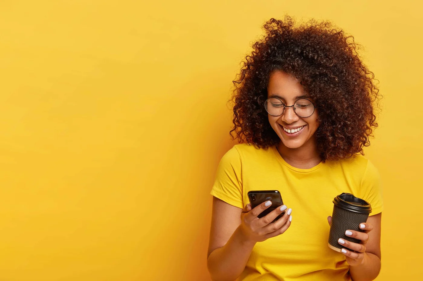 A user looking at a phone with a satisfied expression